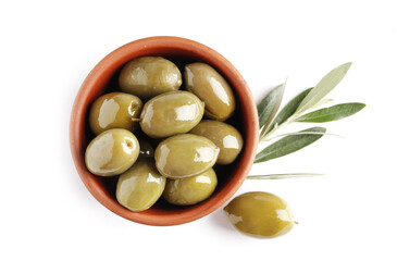 Bowl of fresh olive oil and green olives with leaves isolated on white background. View from above