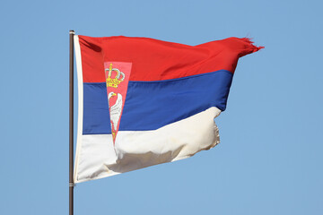 Serbian flag flying on flagpole