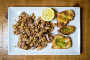 Plate of sea food with slices of bread