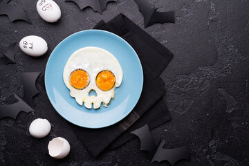 Fried eggs in the shape of a skull. Halloween breakfast.
