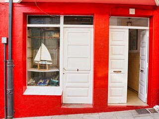 Red door entrance with boat shop