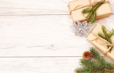 Christmas background and wallpaper. Happy New Year composition. Christmas gift, pine cones, fir branches on wooden white fllor.