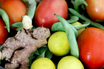portrait view of mix vegetable tomato, ginger, lime and green peas