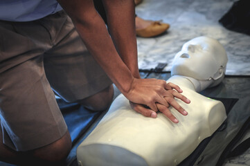 Demonstrating life-saving with a heart pump by hand.