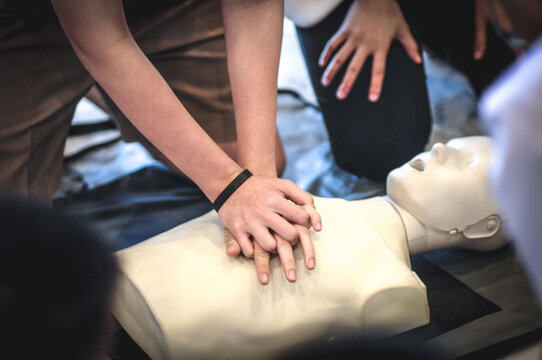 Demonstrating life-saving with a heart pump by hand.