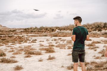 Man operating a drone on the desert