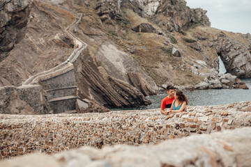 Young couple on the bridge of Gaztelugatxe Island