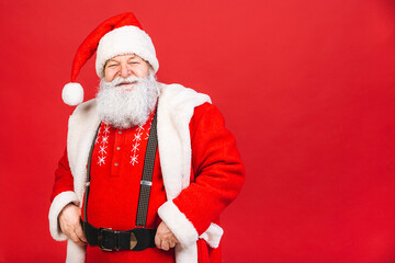 Santa Claus standing isolated on red background. Christmas and new year concept.
