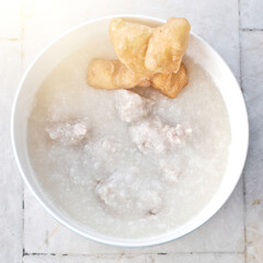 Pork porridge in a white bowl. top view