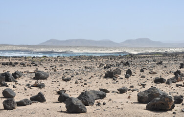 Fototapeta na wymiar dunkle Steien in der wüste auf der Kanarischen Insel Fuerteventura