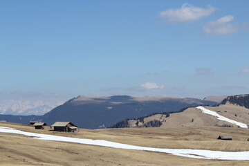 melting snow on an alm in the italian alps under blue sky