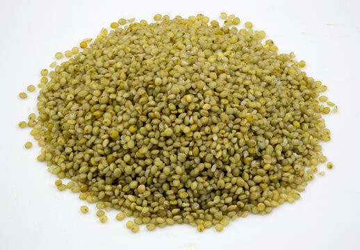 Close-up of browntop millet grains on a  white background