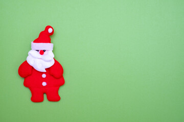 Santa Claus on green background and copy space for text. Cute santa claus made of cloth.