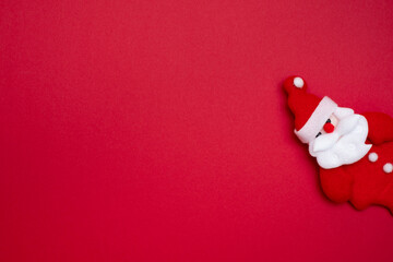 Santa Claus on red background and copy space for text. Cute santa claus made of cloth.