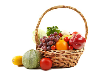 Ripe fruits and vegetables in basket on white background