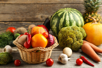 Ripe fruits and vegetables on grey wooden table