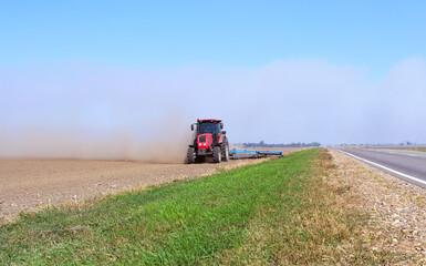 Fototapeta premium disking the field after harvest for better fertilization of the soil and getting rid of weeds
