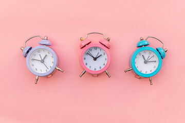 Simply minimal design three ringing twin bell classic alarm clock Isolated on pink pastel...