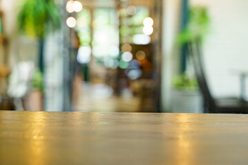 Soft focus background of wooden table and bokeh in cafe shop.