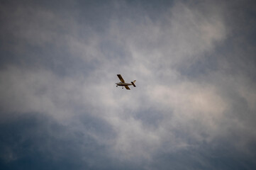 small private plane flying in the clouds