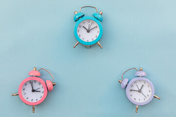 Simply minimal design three ringing twin bell classic alarm clock Isolated on blue pastel...