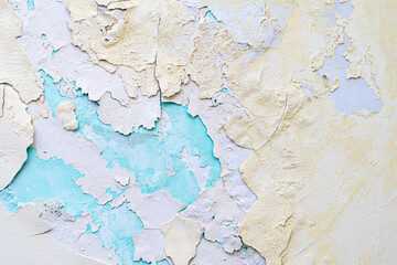 Colorful background. Layers of peeling plaster of different colors. Yellow and blue