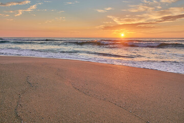 Sunset on the beach of Mar de Fora, Finisterre, Galicia, Spain. This beach is the westernmost beach in Europe, so people go there to see one of the most impressive sunsets in Northern Spain