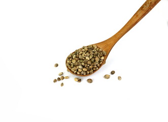 Hemp seeds in a wooden spoon isolated on white background. Super food hemp seed. Cannabis Hemp seeds close up.
