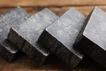 Natural tar soap on wooden table, closeup