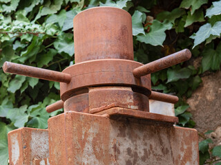 Old piece of rusty machinery abandoned in a factory yard