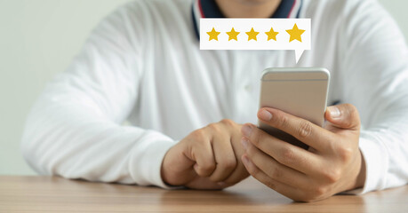 Business man wear green shirt using smart phone  for digital online marketing on office desk. Business & finance technology concept.icon online e-commerce global market shopping,banking and payments.