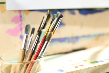 Fototapeta premium background of art brushes and easel 