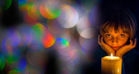 sad little girl with a candle