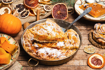 Homemade pumpkin pie with various ingredients