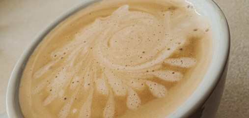 Cafe latte with art in a white mug