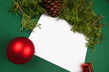 Fototapeta na wymiar White leaf on a green Christmas background