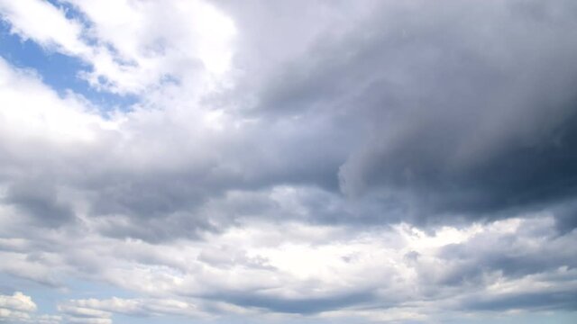 Clouds float across the blue sky. The sun's rays illuminate the Cirrus clouds behind. Multi-layered clouds in the autumn sky of the black sea coast.