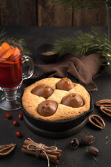 Cozy Christmas composition in brown colors. Homemade pie and mulled wine, side view, vertical orientation. The concept of new year and Christmas.