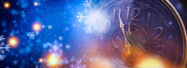 New Year banner with clock. Neon lights, holiday lights. Time shows 12 o'clock, New Year and Christmas 2021. Winter holiday background.