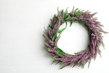 Beautiful autumnal wreath with heather flowers on white background, top view. Space for text - obrazy, fototapety, plakaty