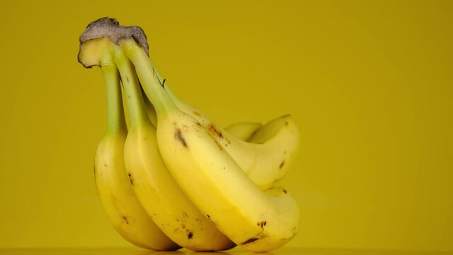 Banana. Yellow bananas 360 rotate on yellow background.