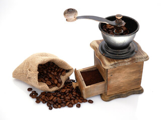 Coffee in a jute bag and ground in an old vintage grinder.