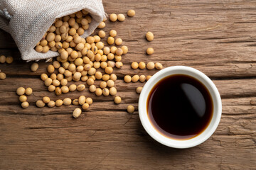 Soy sauce and soy bean on wooden table .Top view.