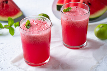 Watermelon smoothie topping with fresh mint leaves on wood background