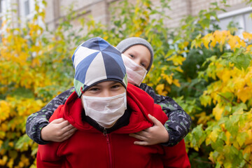 schoolchildren in protective masks in the street