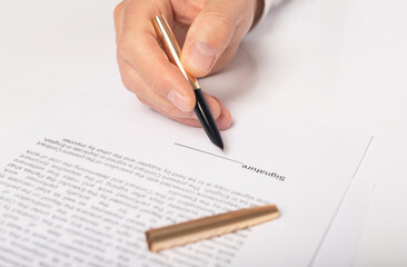 Contract signing concept. Businessman hand with pen over document closeup, space for signature