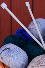 basket with threads for knitting, knitting needles,  background