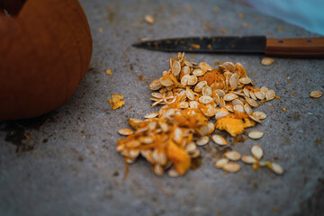 Chico joven con mascarilla por covid 19 preparando calabaza de halloween
