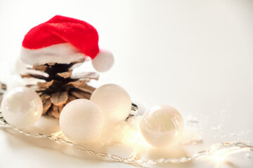 Christmas background with white glittering balls and Santa hat