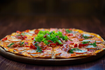 Classic pizza with salami, cheese, tomatoes, bell peppers, salad greens. Margherita Italian pizza with melted mozzarella cheese and tomato.